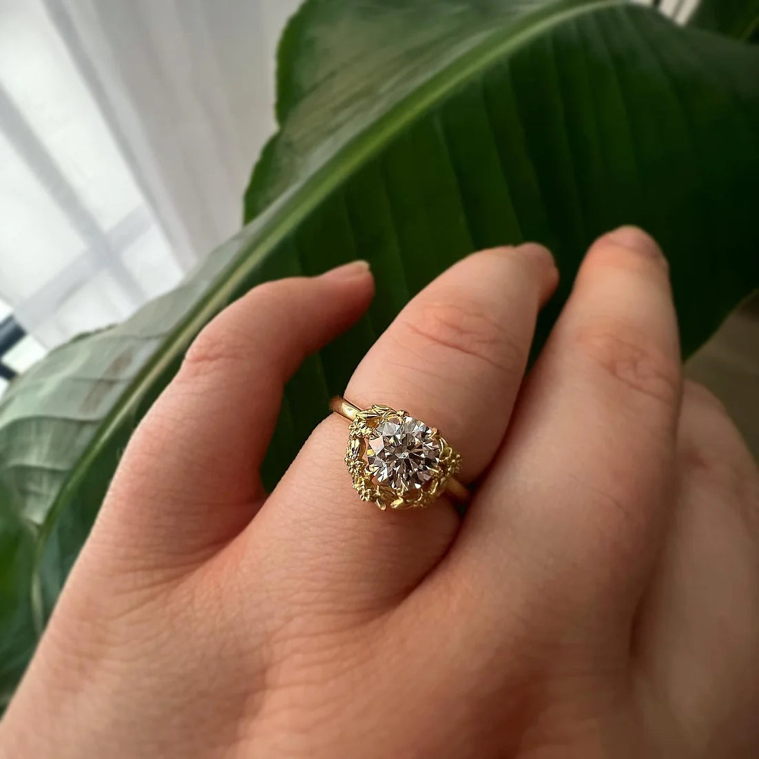 18ct yellow gold Blossom halo engagement ring by London jewellery designer, Georgina Yvonne. Nature inspired design with round brilliant cut diamond centre 