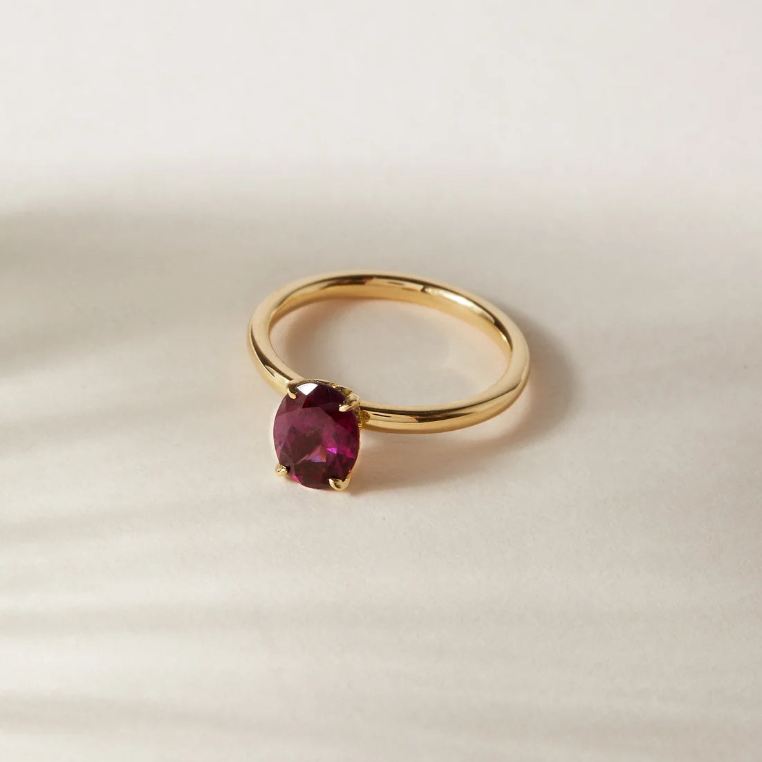 Daisy Garnet Engagement Ring by London jewellery designer, Georgina Yvonne. Nature inspired solitaire design with floral gallery and oval garnet centre stone 