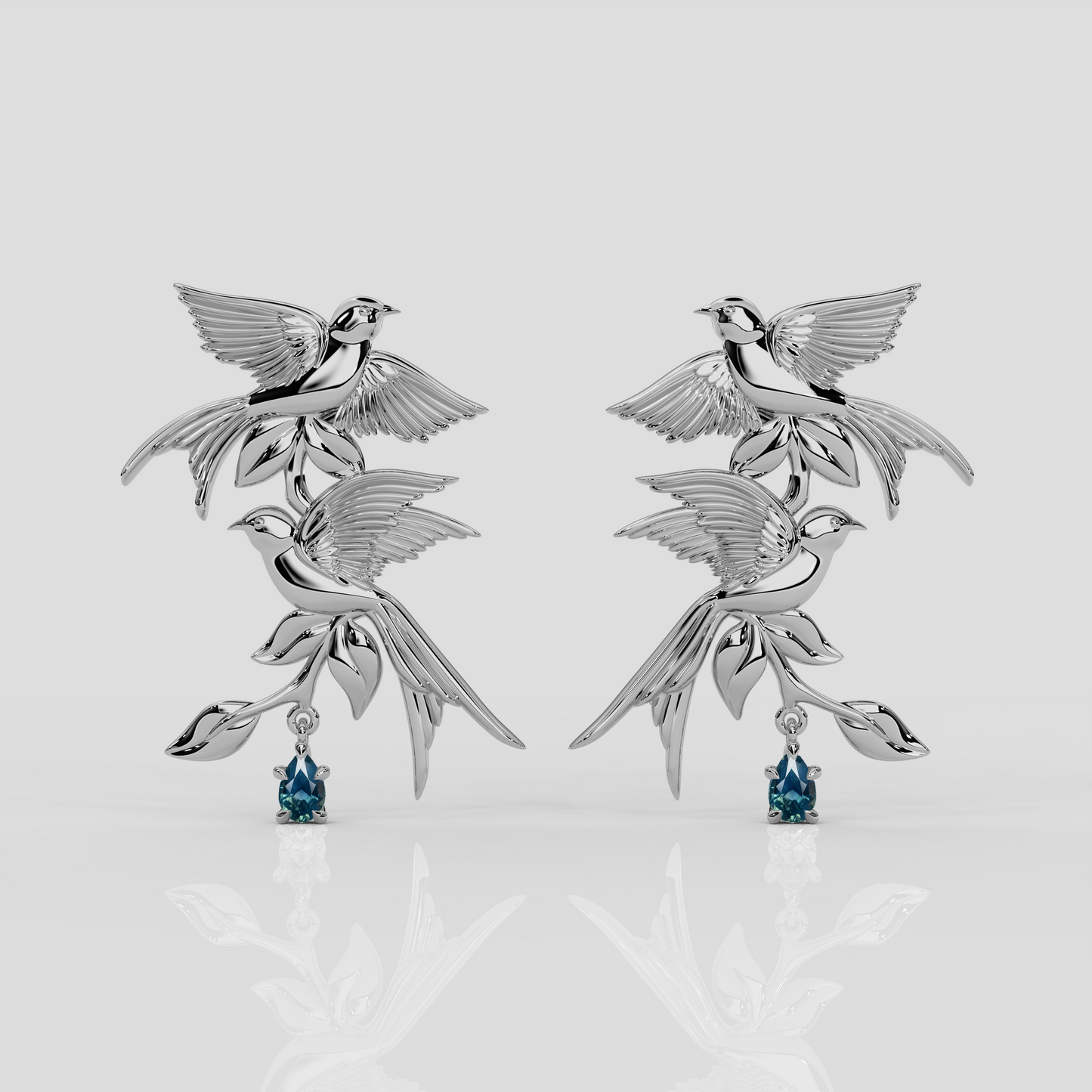 Platinum and teal sapphire Bird Song Earrings by London jewellery designer, Georgina Yvonne, from the award winning Wonderland jewellery collection.